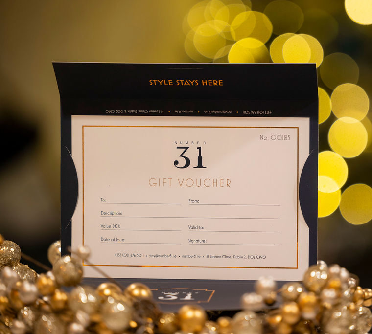 Elegant Number 31 gift voucher displayed with festive bokeh, inviting guests to experience luxury accommodation in Dublin.